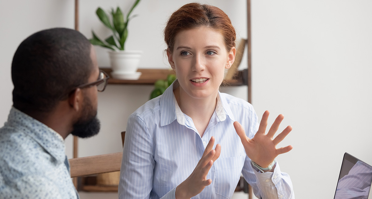 A lady talking to a man with hand gestures